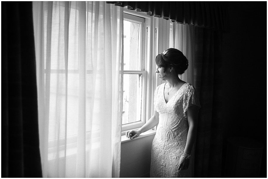 Wedding Photography at Prestwold Hall: Portrait of bride looking out of window