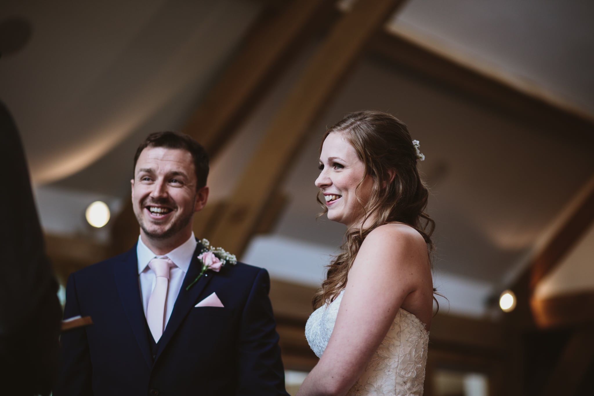 Bride and groom both smiling during ceremony