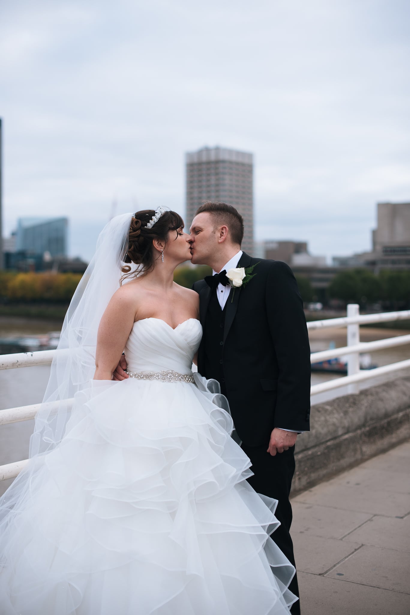 Bride and groom having a kiss on Westminster Bridge