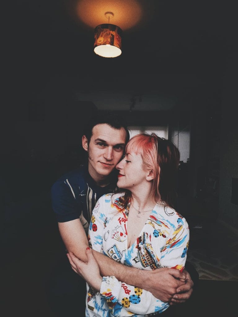 couple embrace for portraits via phone photo shoot