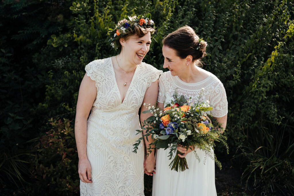 Brides laughing together wedding photography at Thorpe Garden