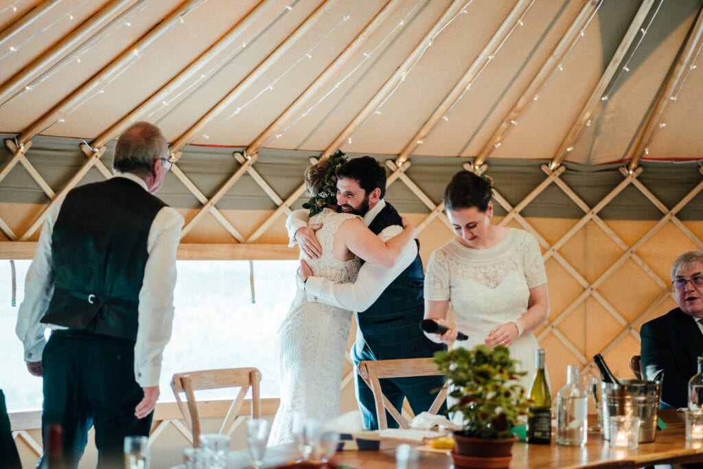 Bride hugs brother.