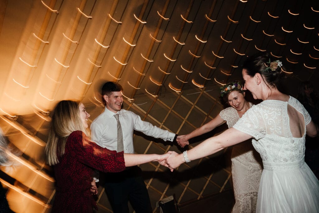 Brides in a Ceilidh dance at Thorpe Garden.