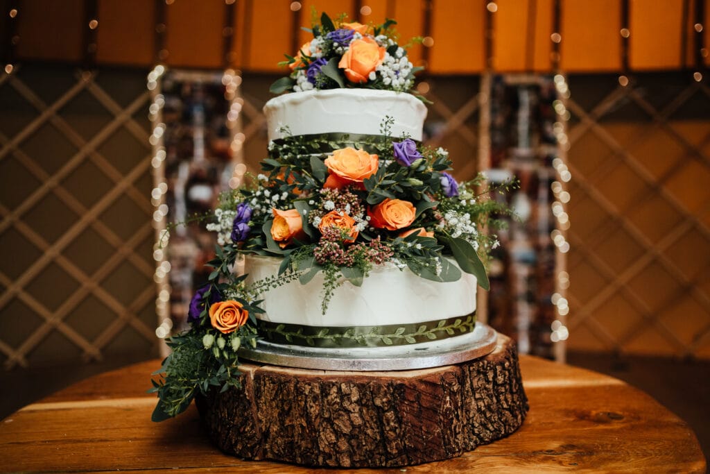 Wedding cake adorned with flowers at Thorpe Garden