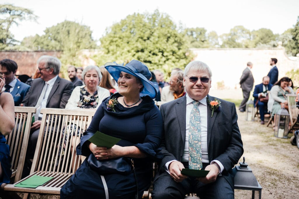 Parents at ceremony, seated and smiling