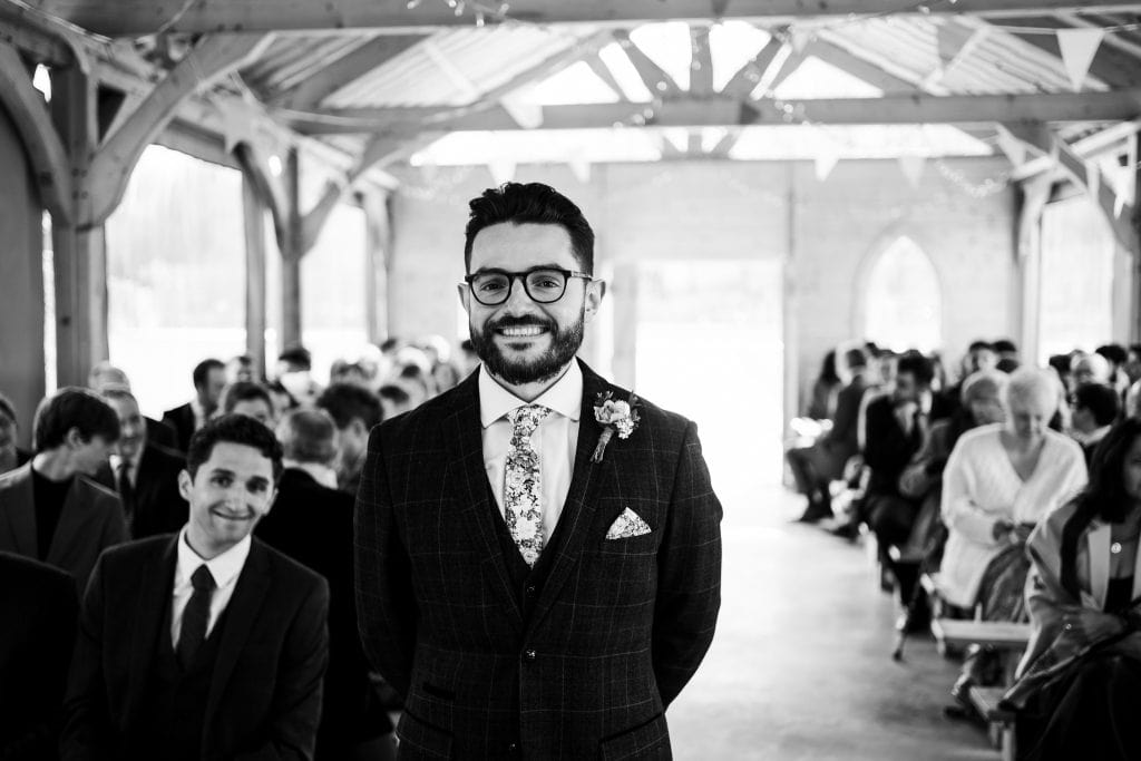 Groom waiting at the front of ceremony venue at The Hidden Hive
