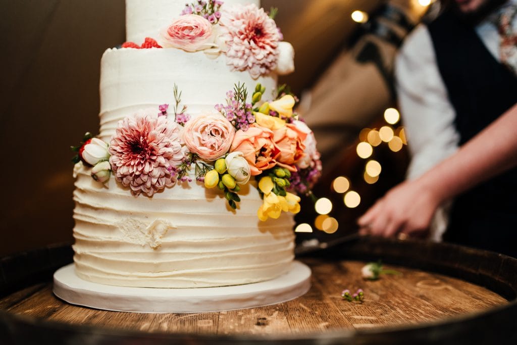 Close up of cutting wedding cake