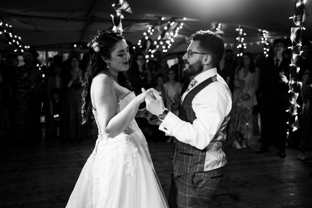 Black and white photo bride and groom first dance in tipi Hidden Hive