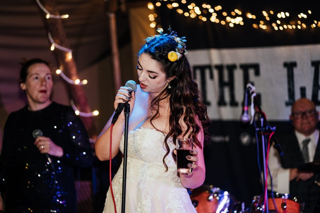 Bride sings into microphone