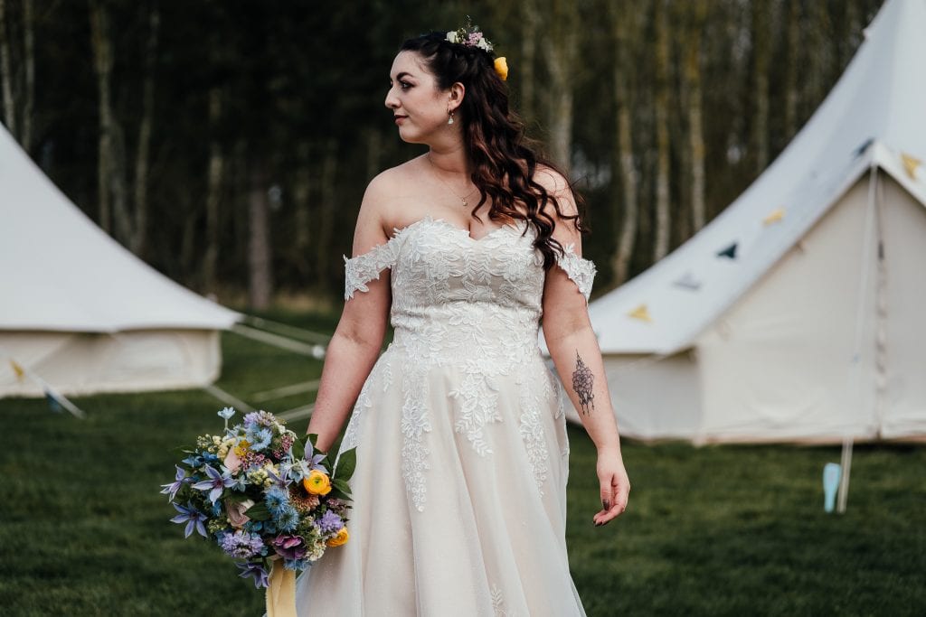Bridal portrait near bell tents