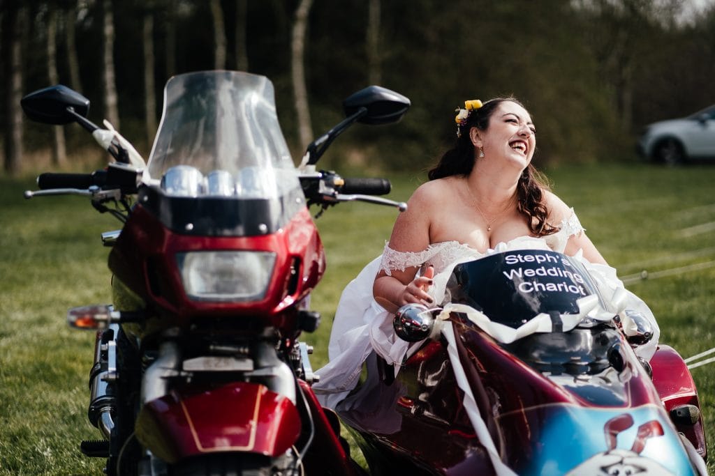 Bride laughing in motorbike side car