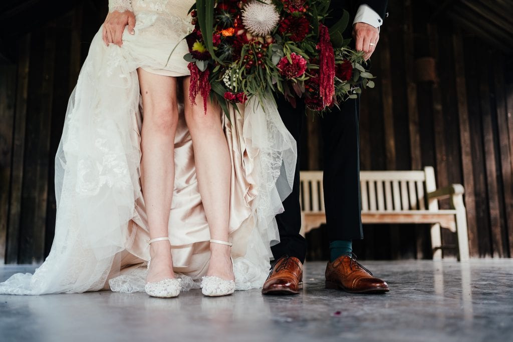 Bride and groom close op of feet and legs