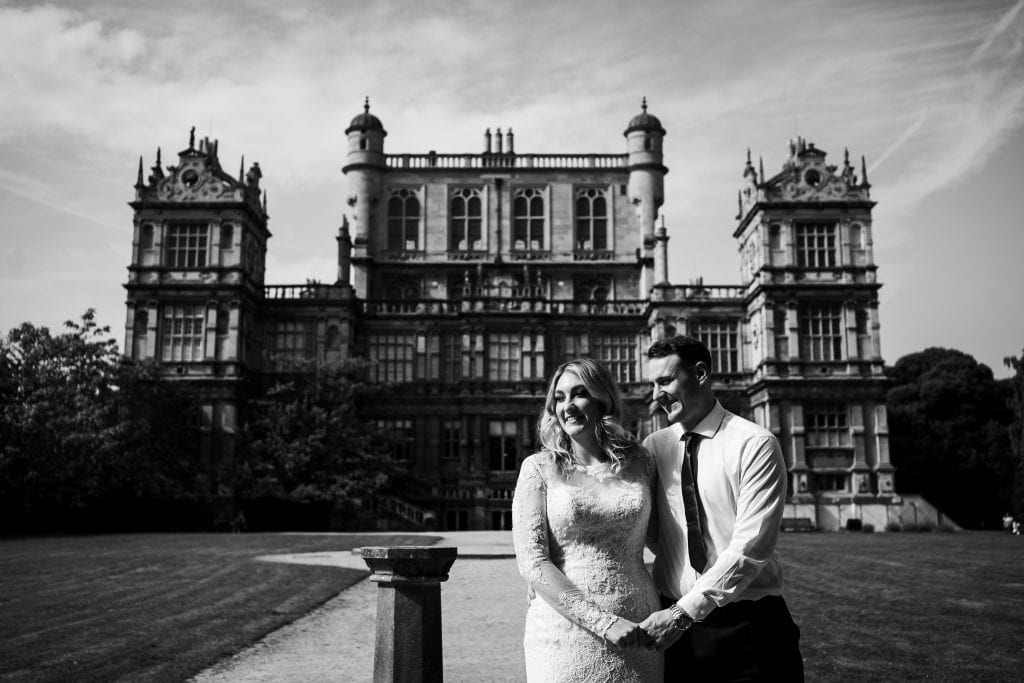 Black and white photo of Bride and groom outside Wollaton Hall