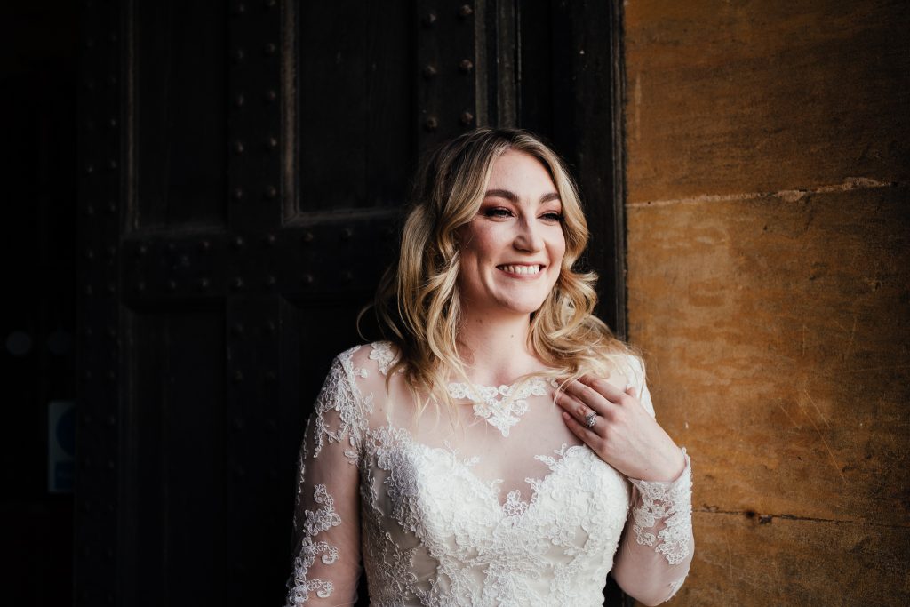 portrait of bride Laura smiling before her wedding