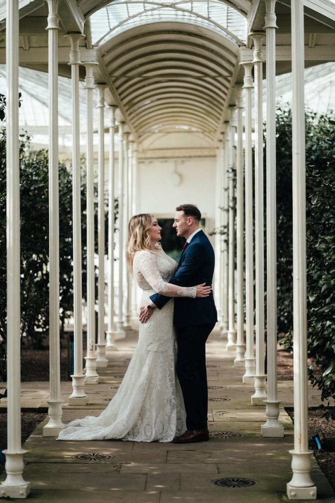 Bride and groom facing each other at Camellia House