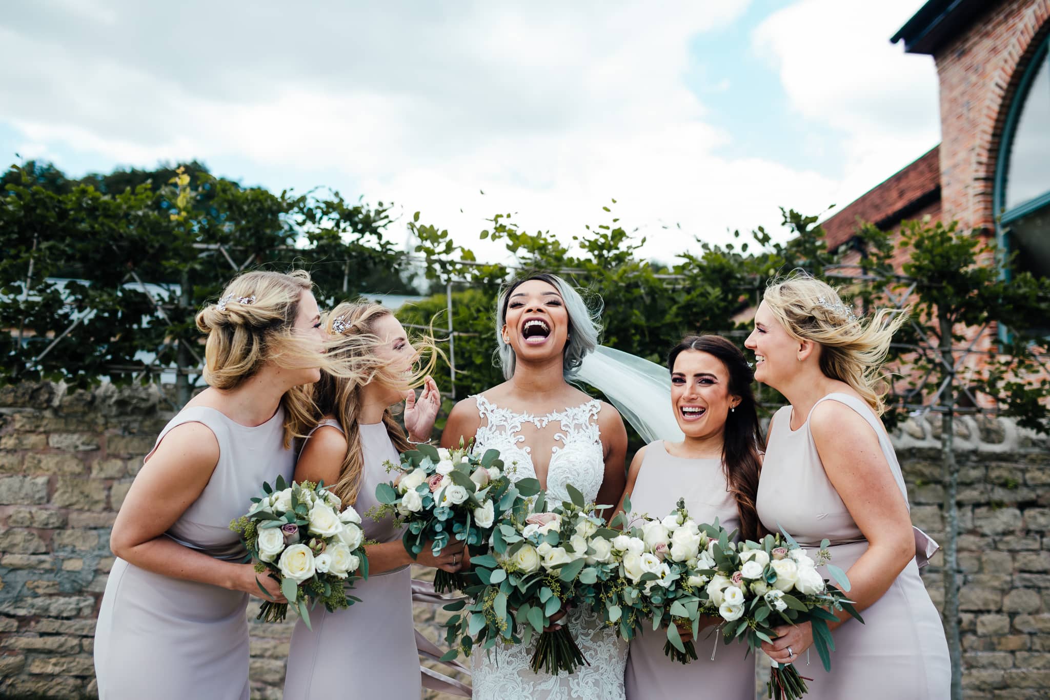 Hazel gap barn wedding. Bride and bridesmaids laughing