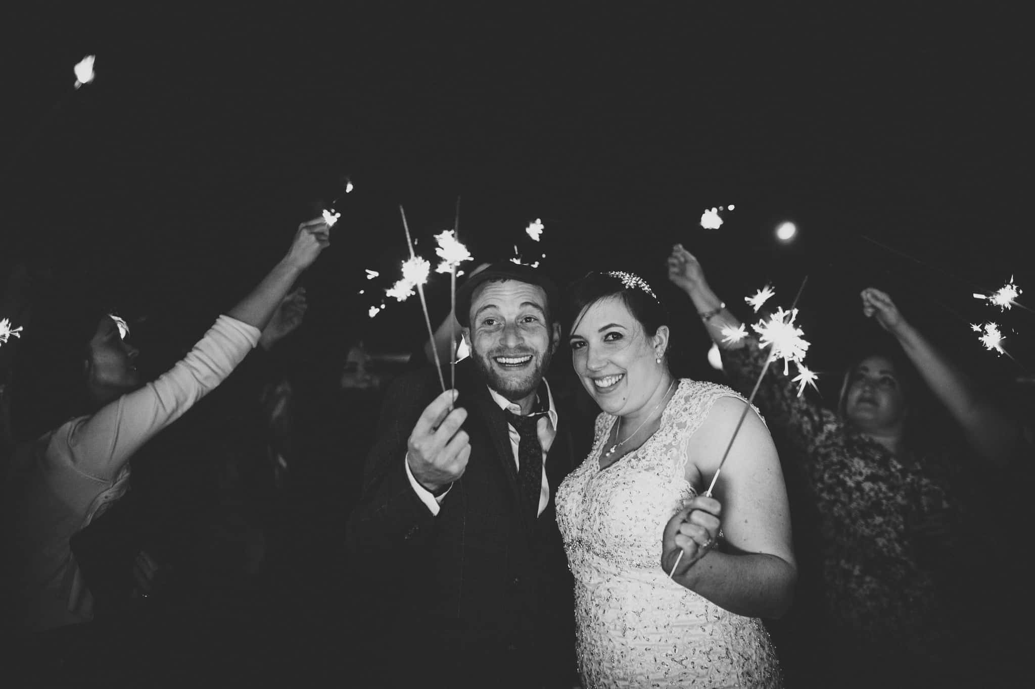 bride and groom holding sparklers at The White Hart Inn, Derbyshire