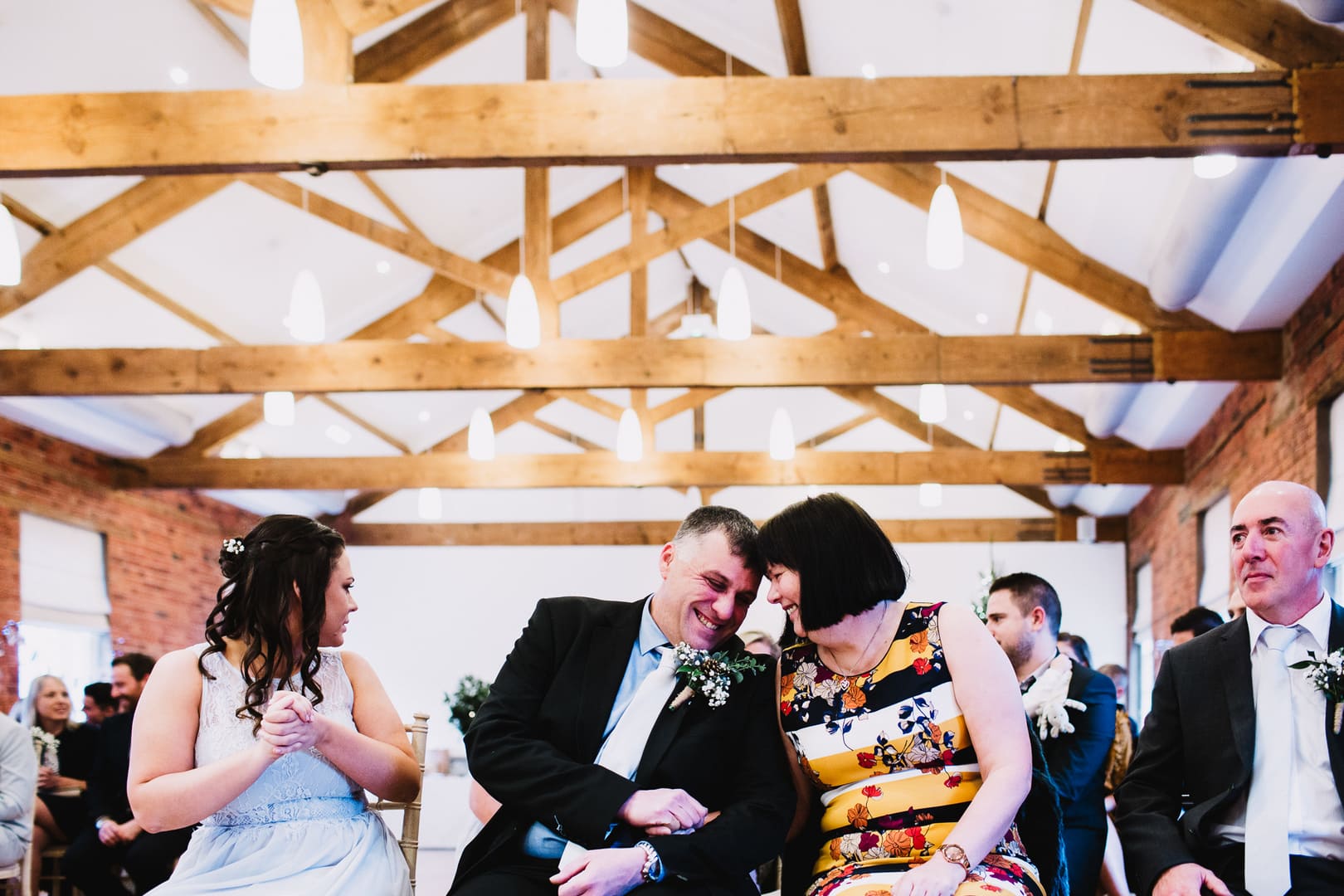 wedding photography at Rufford Mill - bride's dad and wife share a moment