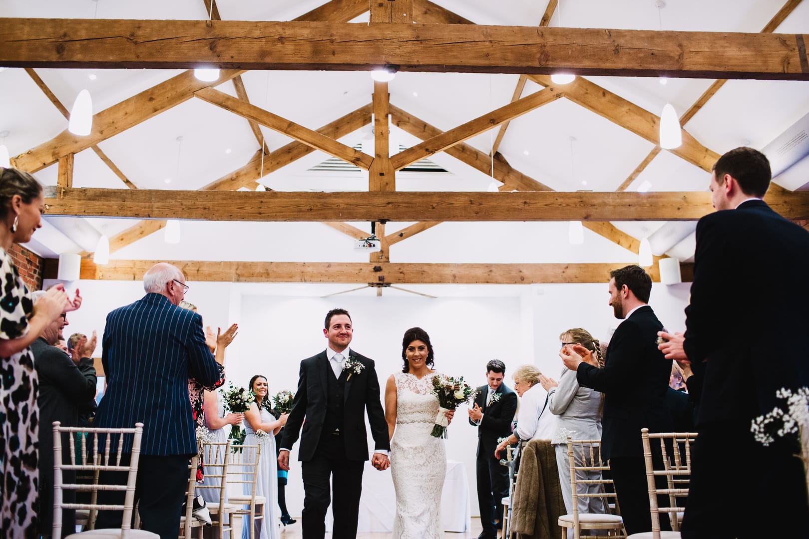 bride and groom walk out at Rufford mill