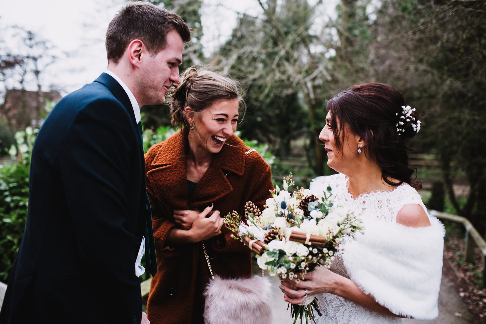 bride and guests laugh together at Rufford Mill