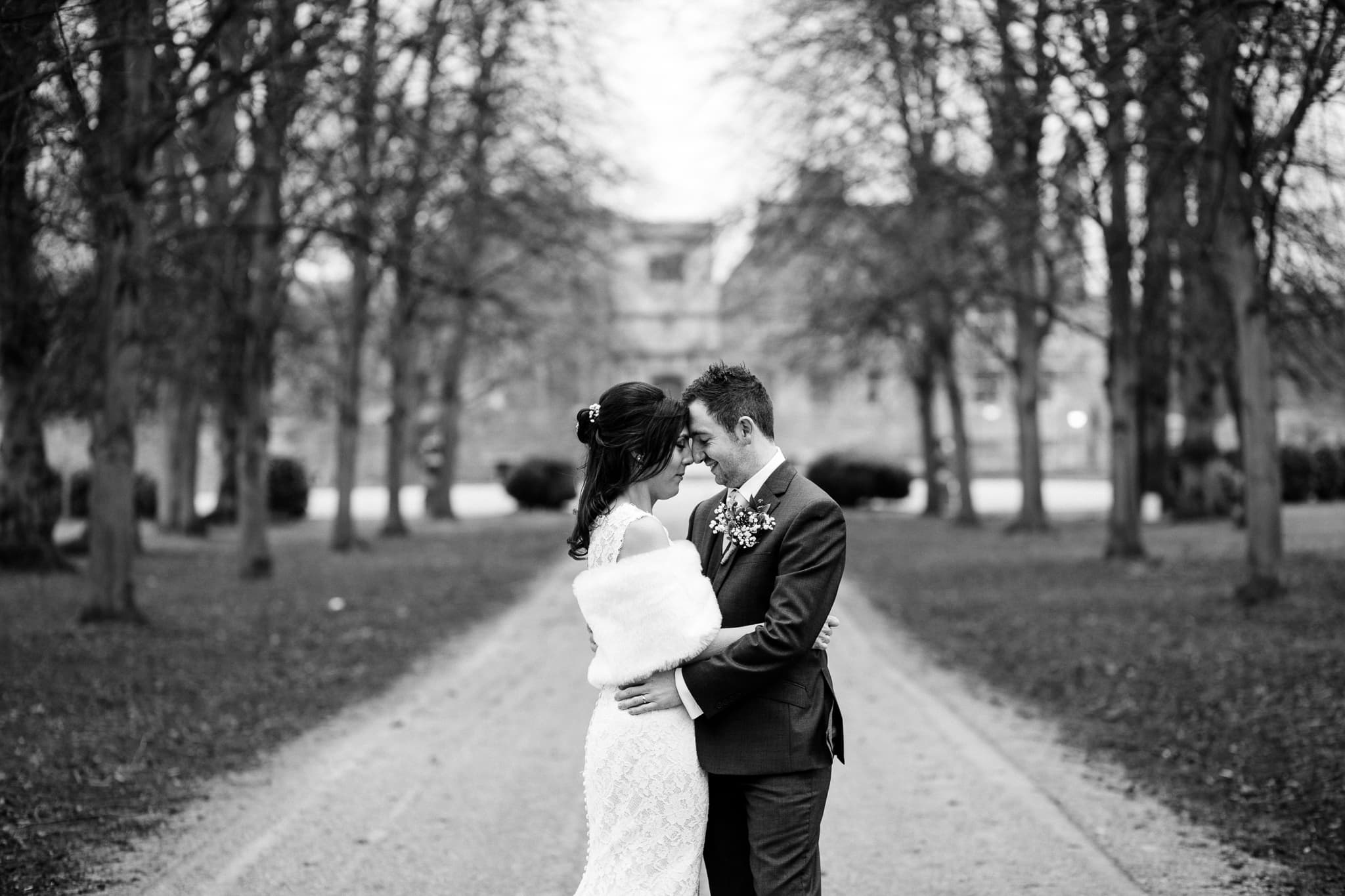 wedding photography at Rufford Mill - black and white of bride and groom on path to Abbey