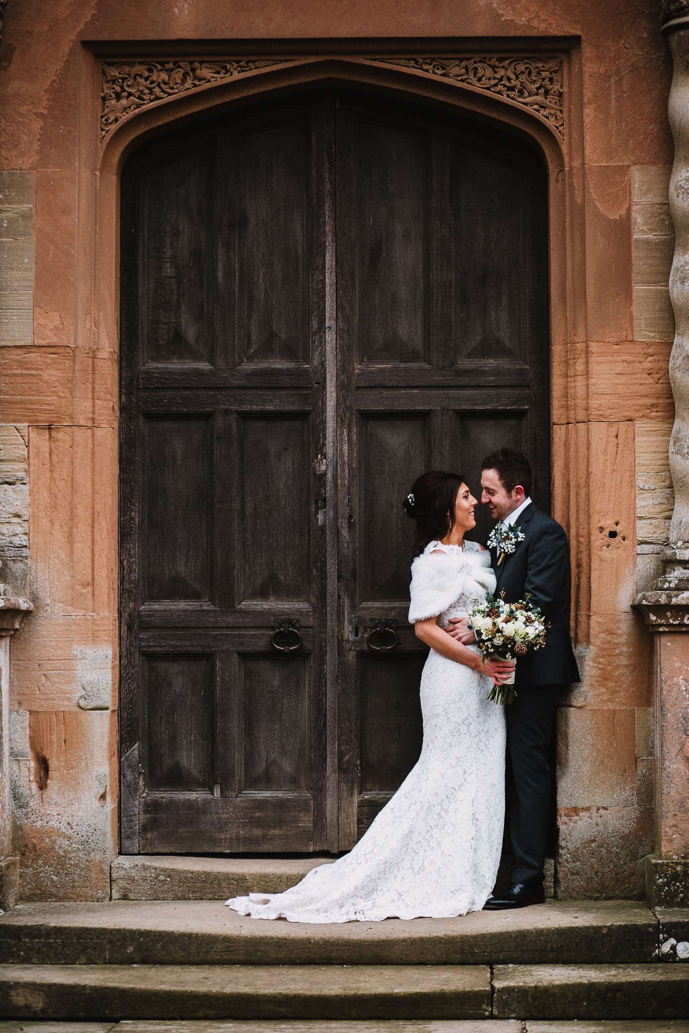 wedding photography at Rufford Mill - bride and groom outside the door of Rufford Abbey ruins