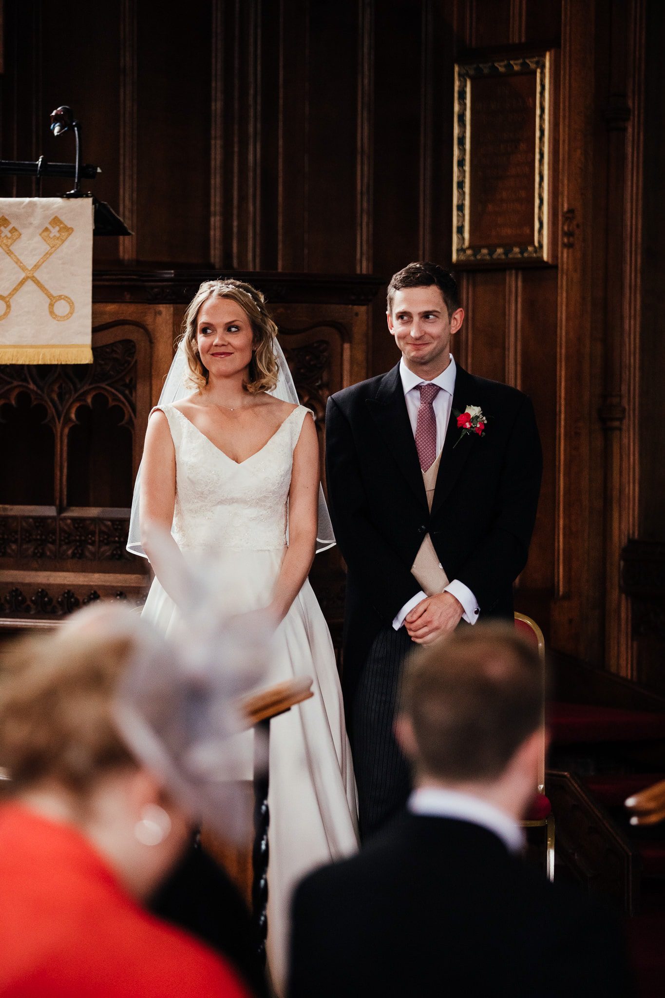 Abbey Farm wedding photography: Bride and groom in church giving the side eye!