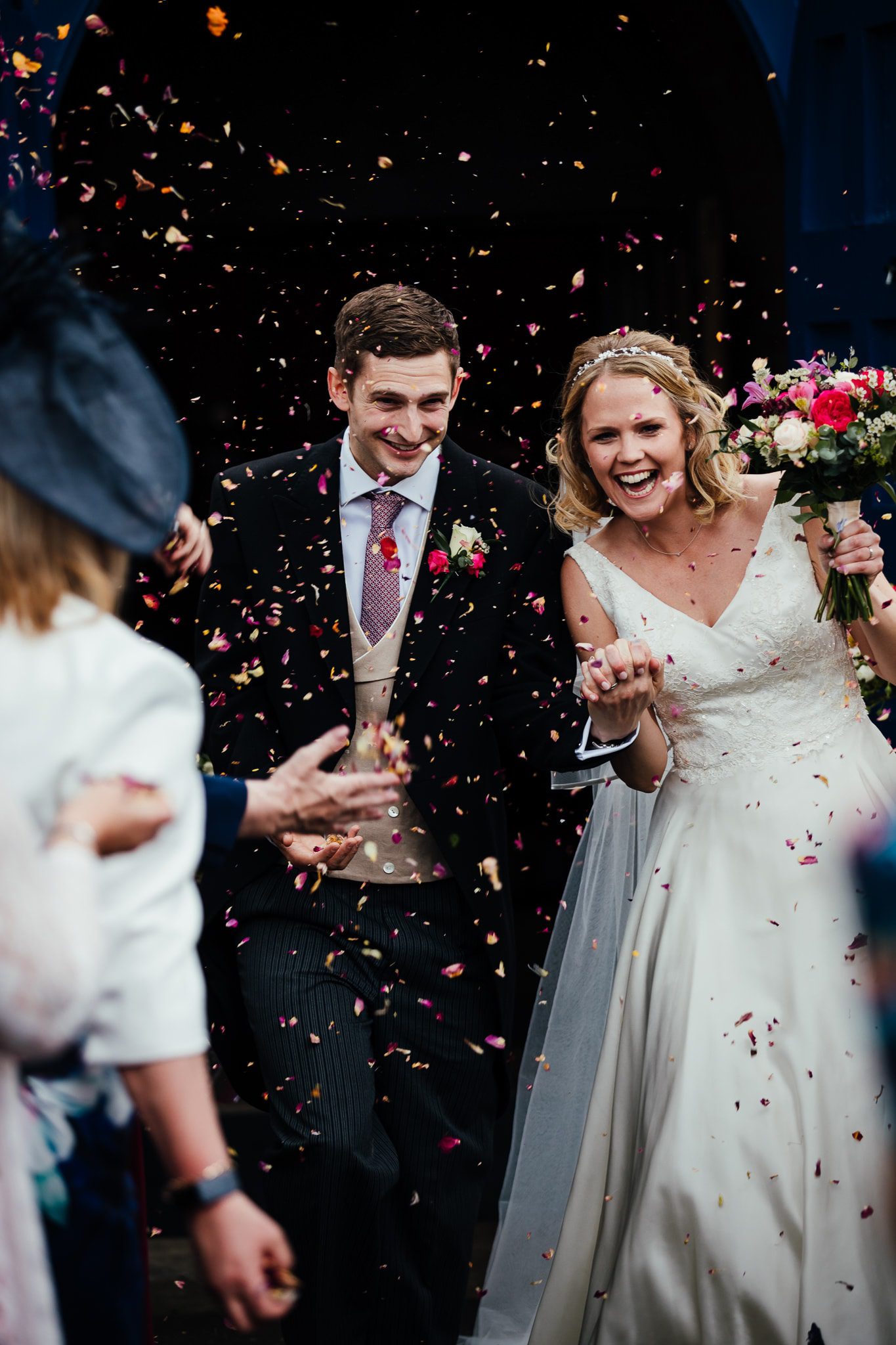 Bride and groom being pelted with confetti