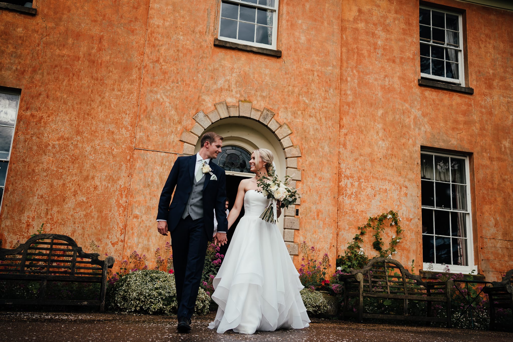 Couple walking outside Langar Hall. One of Nottingham's lovely wedding venues.