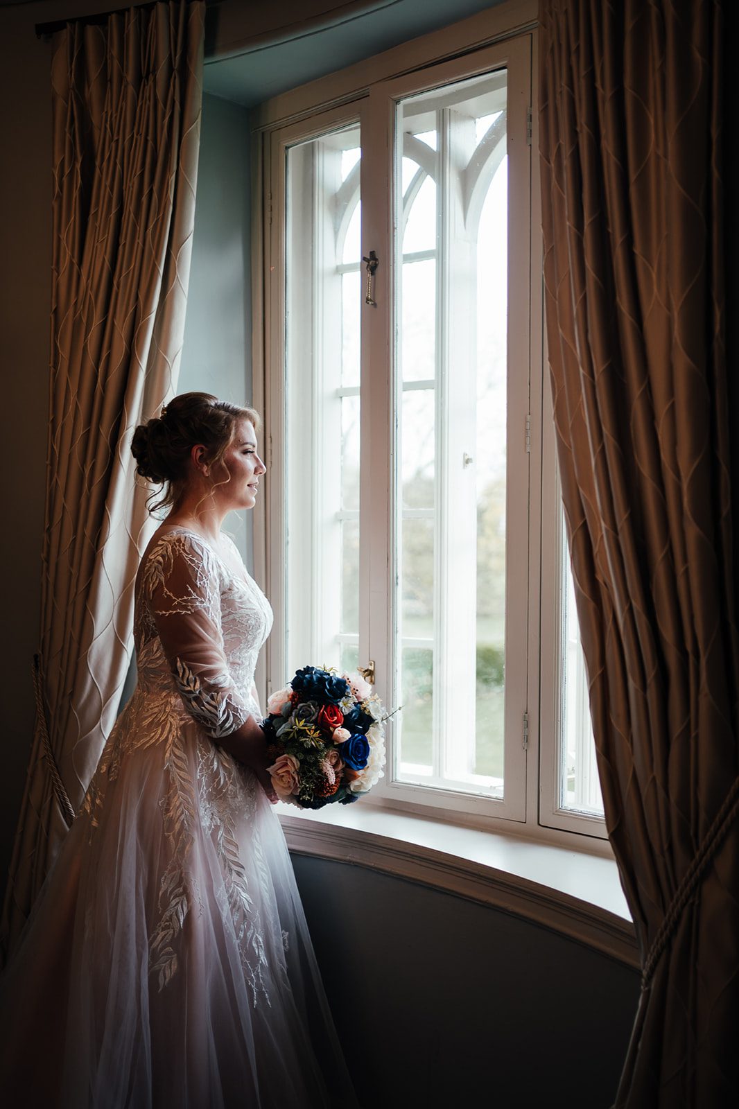 Bride looks out of the window at Cockliffe Country House