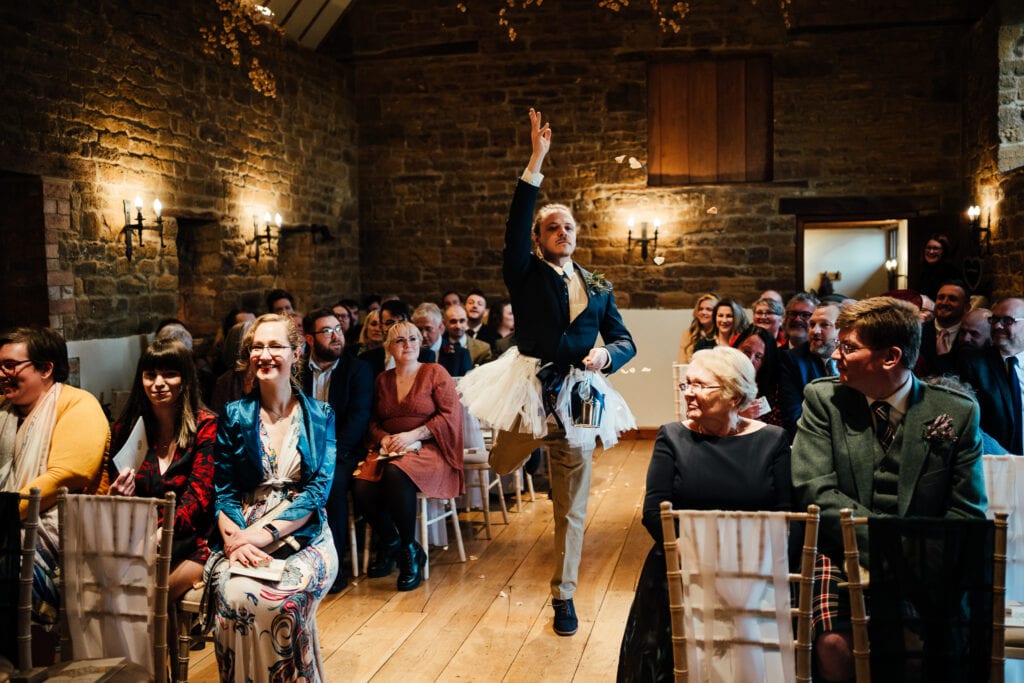 groomsman throwing petals in tutu