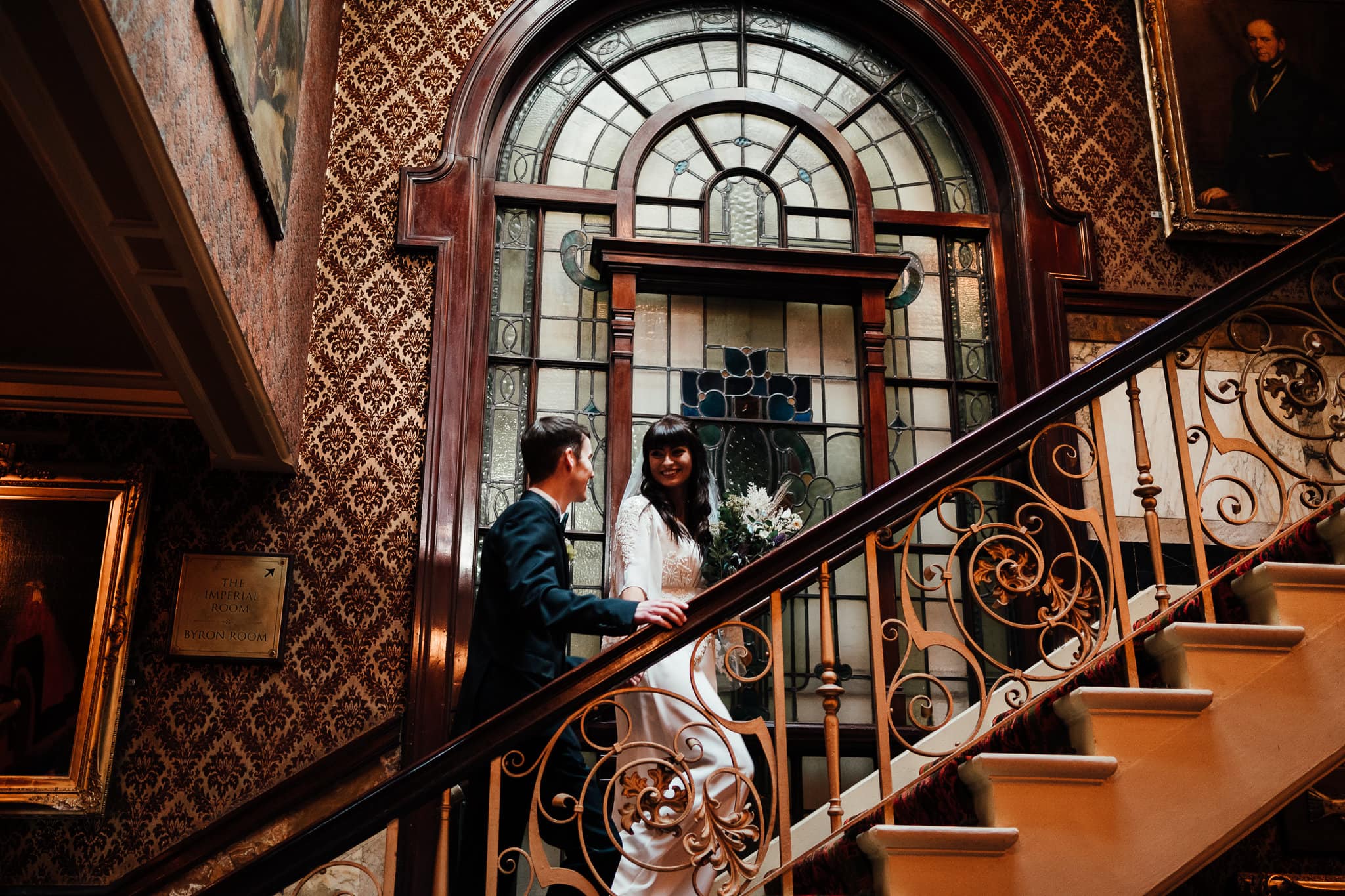 Bride and groom walk up the stairs at The Cosy Club in Nottingham