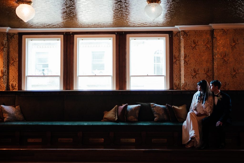 Bride and Groom in window seat at The Cosy Club Nottingham