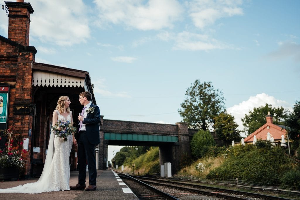 Bride and groom on the platform at Quorn. Their wedding at the Manor House Quorn