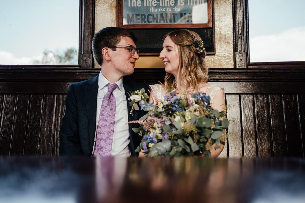 Bride and groom sat in train waiting room
