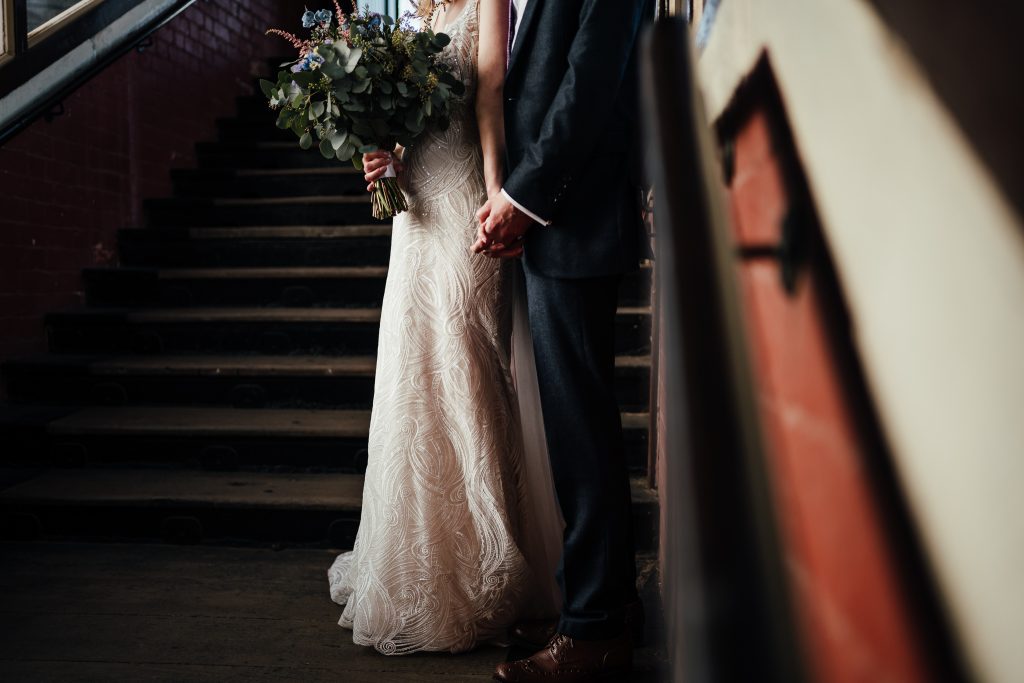 Wedding at The Manor House Quorn: Close up of bride and groom on steps of railway station