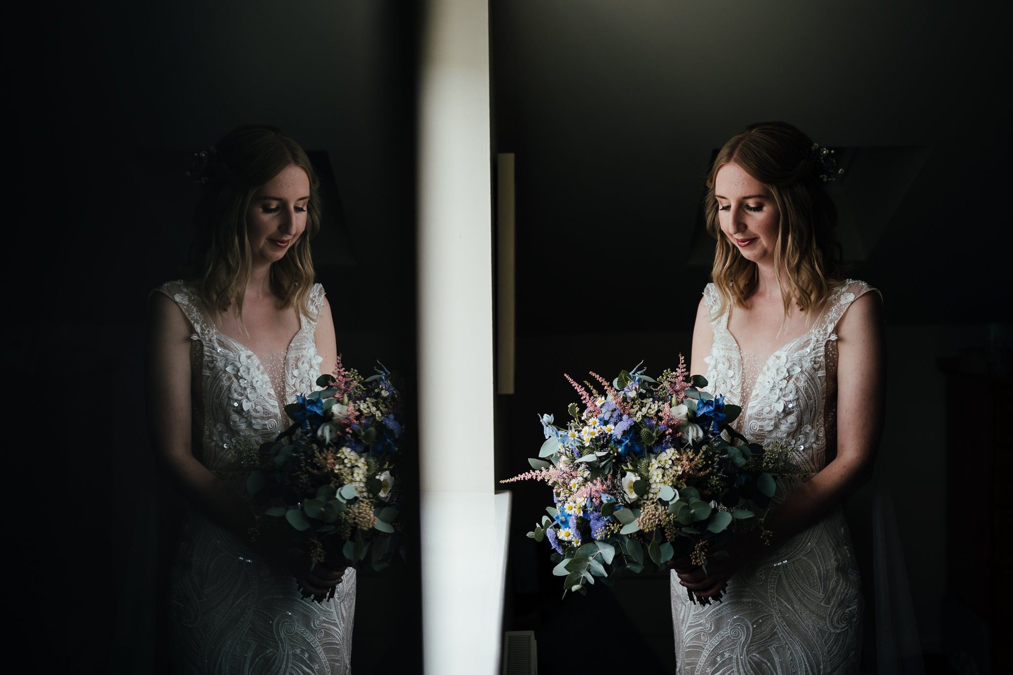 Bridal portrait in window light, with bride reflected in the window pane.