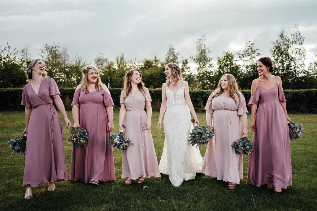 Wedding at The Manor House Quorn: Bride and bridesmaids laughing and walking