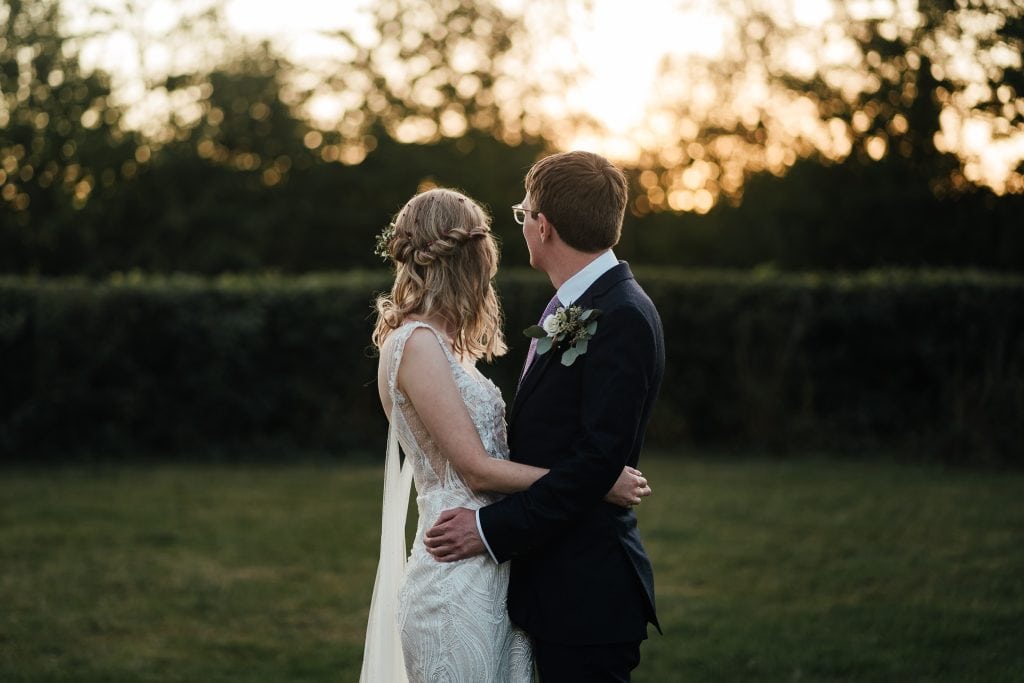 Wedding at The Manor House Quorn: Bride and groom in the golden light looking away from camera.