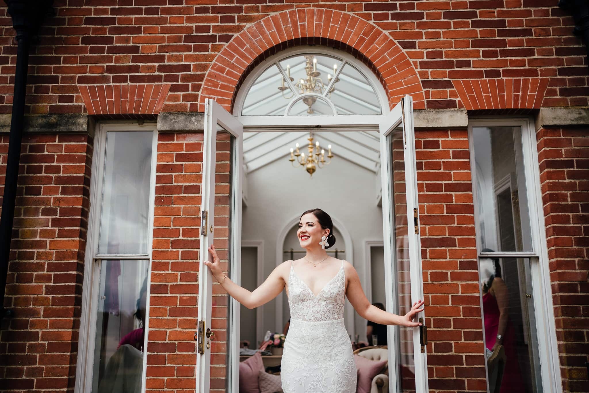 Norwood Park wedding photography - Bride poses in the French doors looking out.