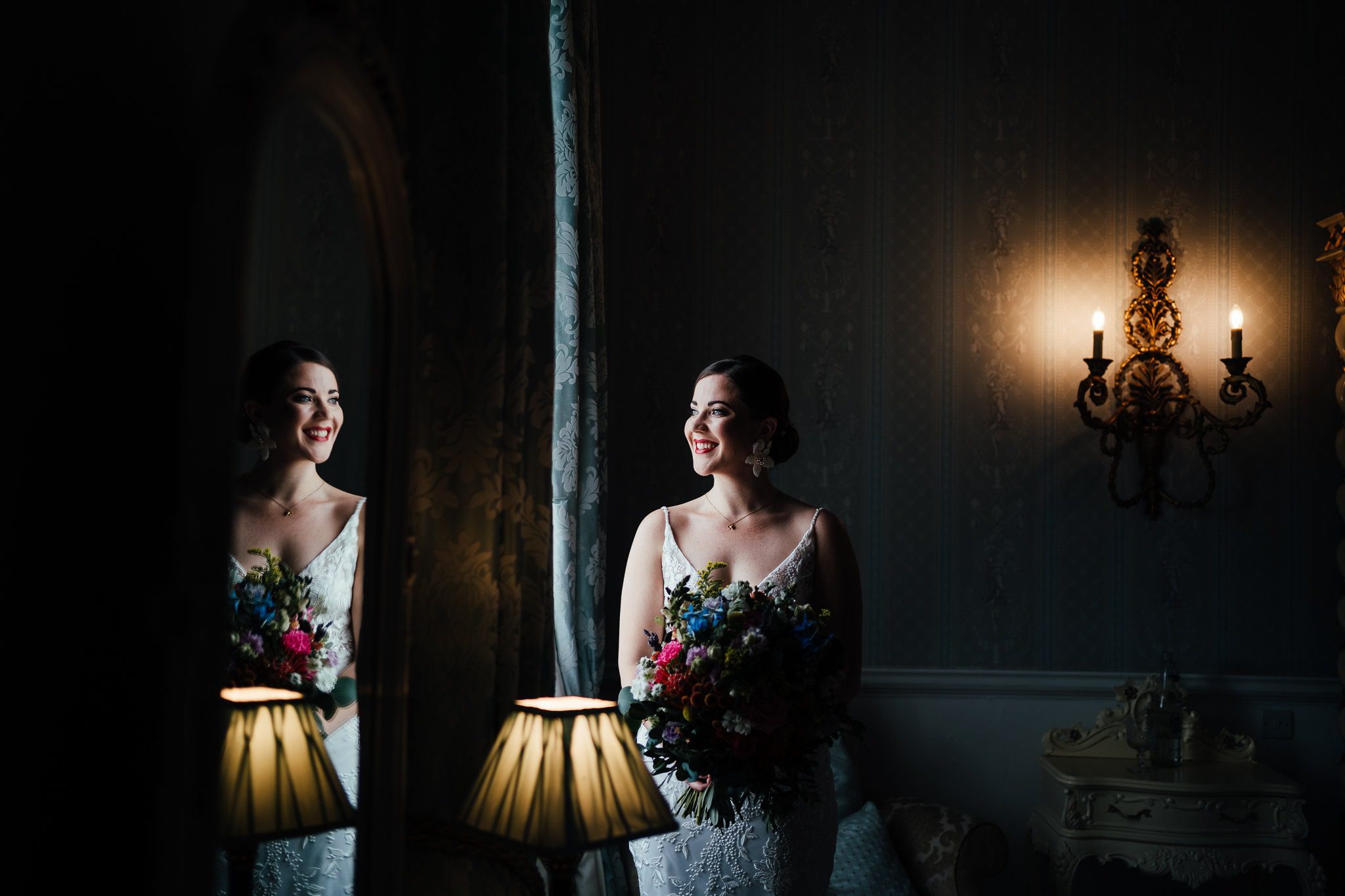 Dramatic window light portrait of the bride in the luxurious bridal suite at Norwood Park