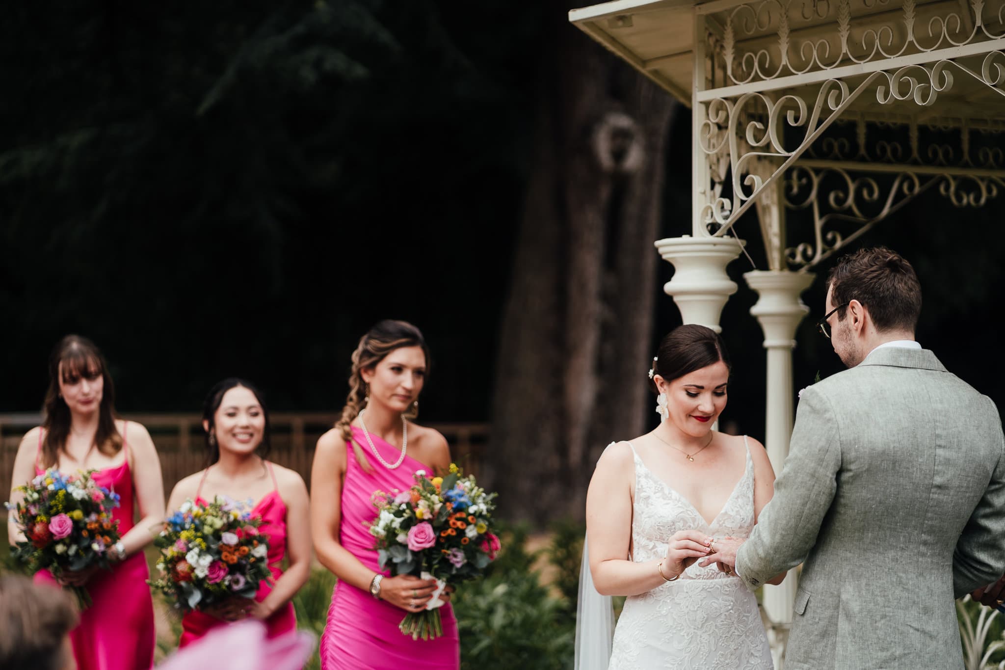 Norwood Park wedding photography - bride and groom exchange rings in outdoor ceremony