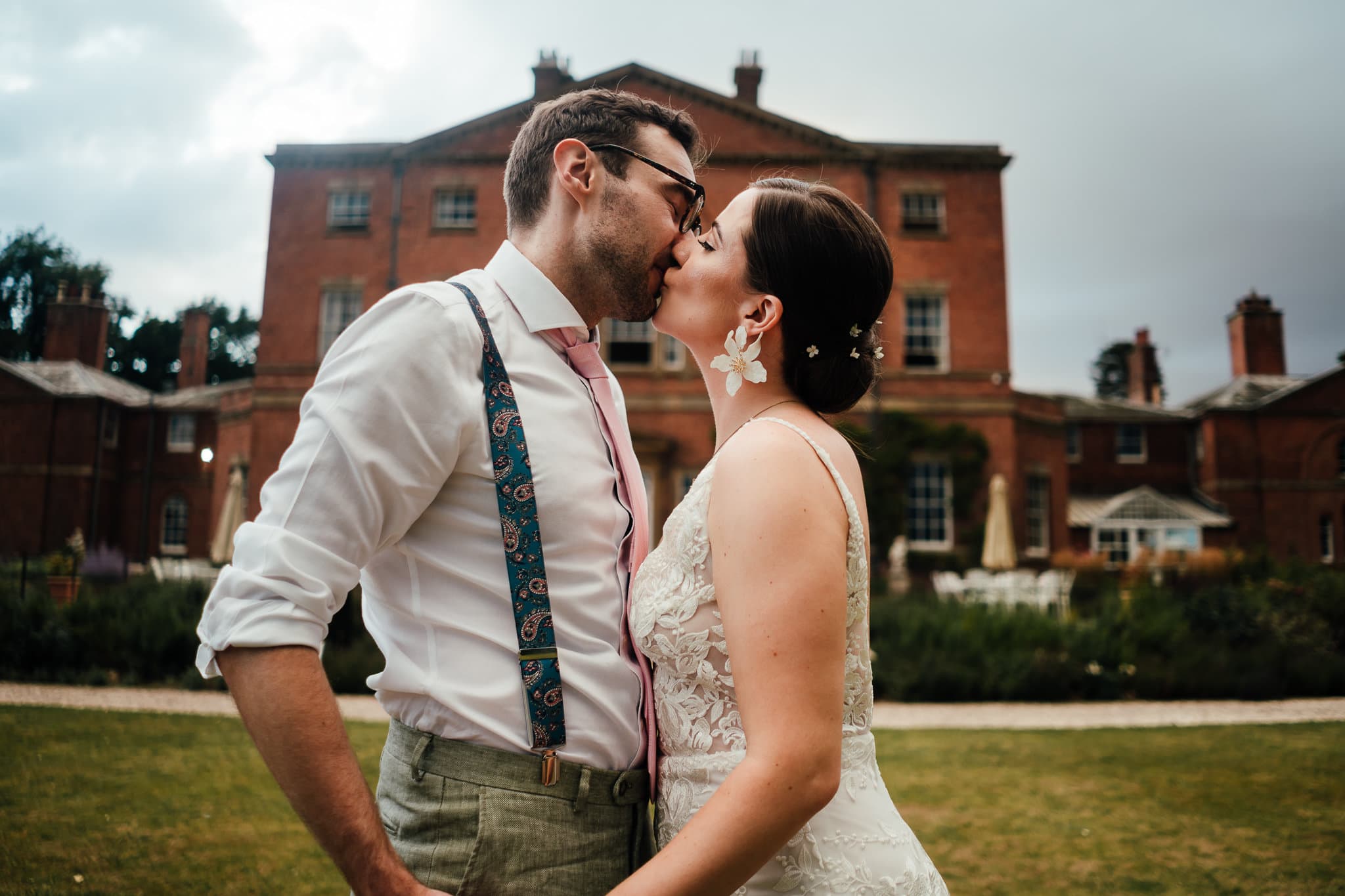 Wedding photography at Norwood Park. Bride and groom kiss in front of the Georgian house at Norwood