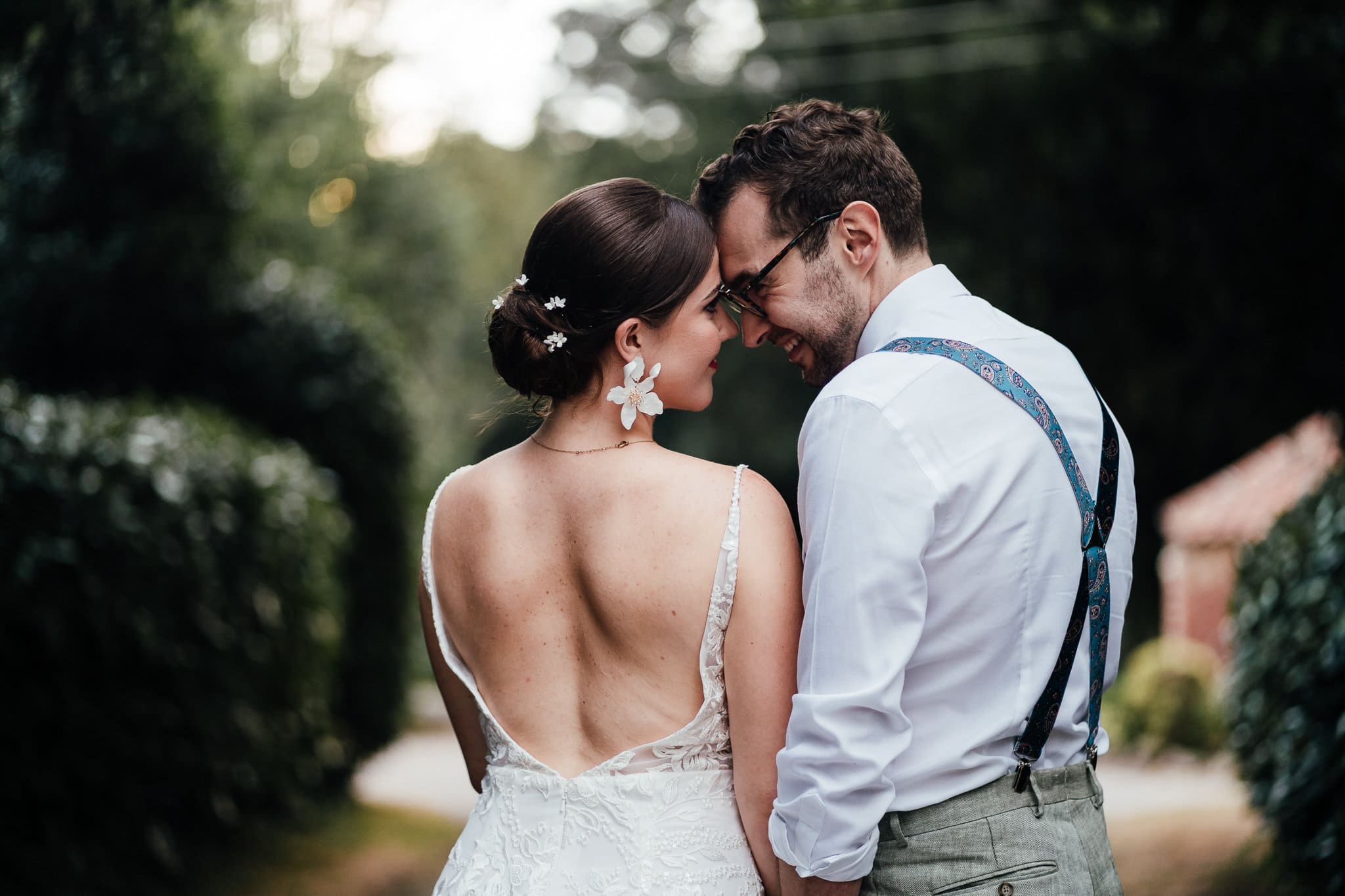 Bride and groom portrait at Norwood Park. Photographed from behind revealing Ellen's gorgeous backless dress