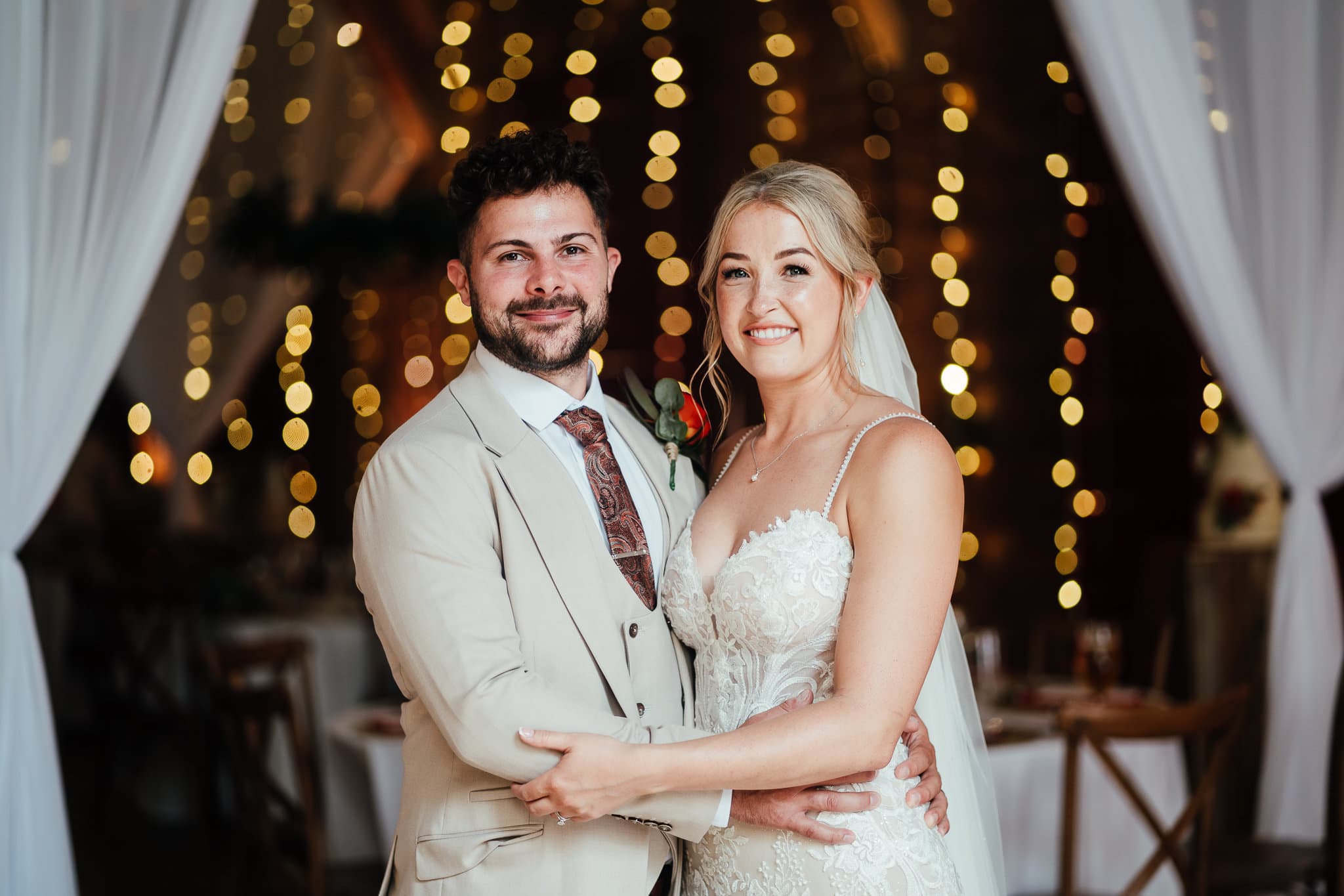 Bride and groom in front of lights at Thoresby Riding Hall