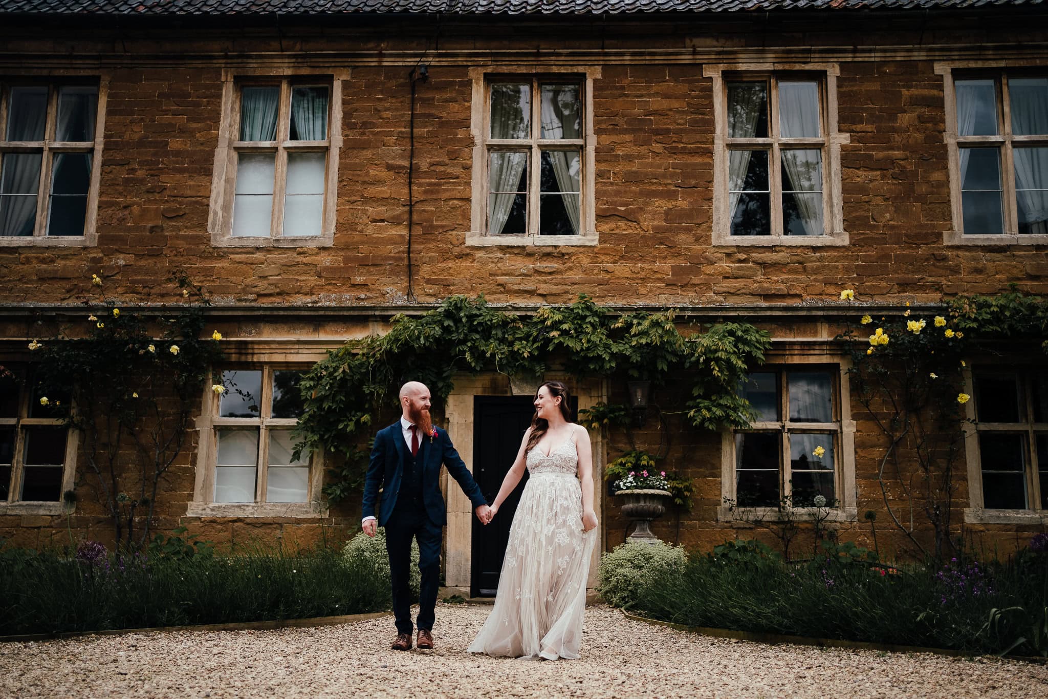Bride and groom outside the front of the house at Allington Manor