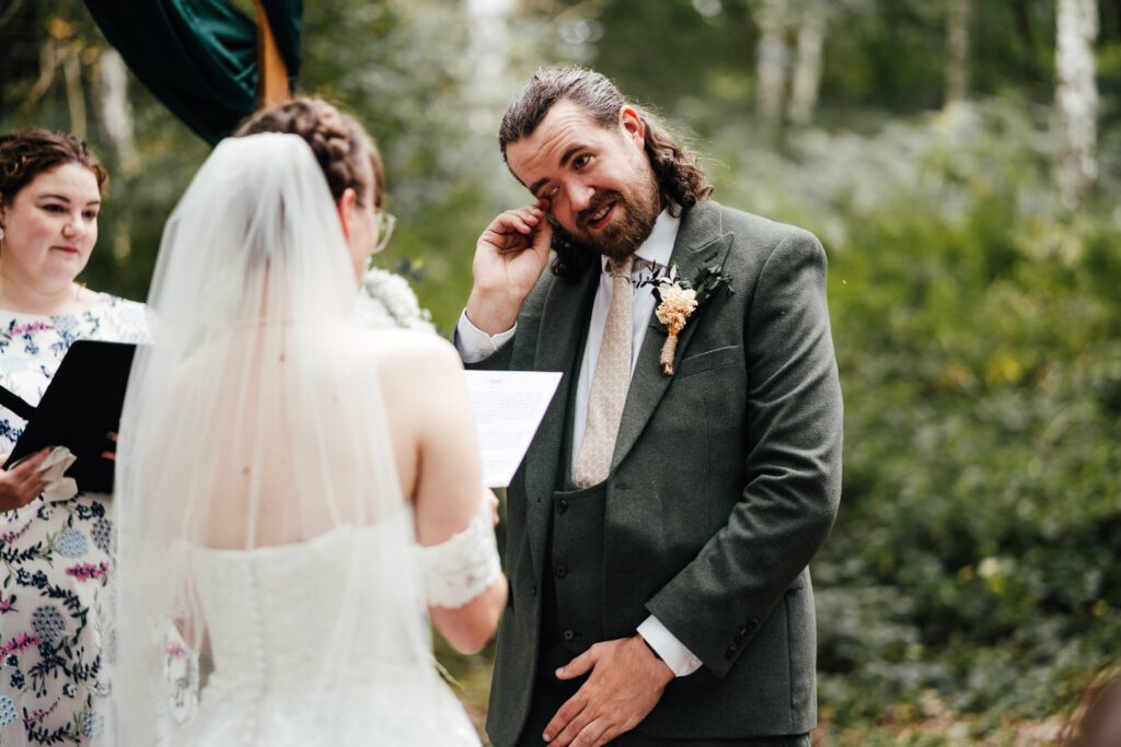 Groom shedding a tear during ceremony