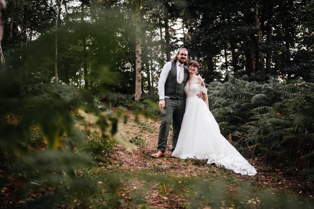 Full length portrait of bride and groom in the woodlands at Sherwood Glade
