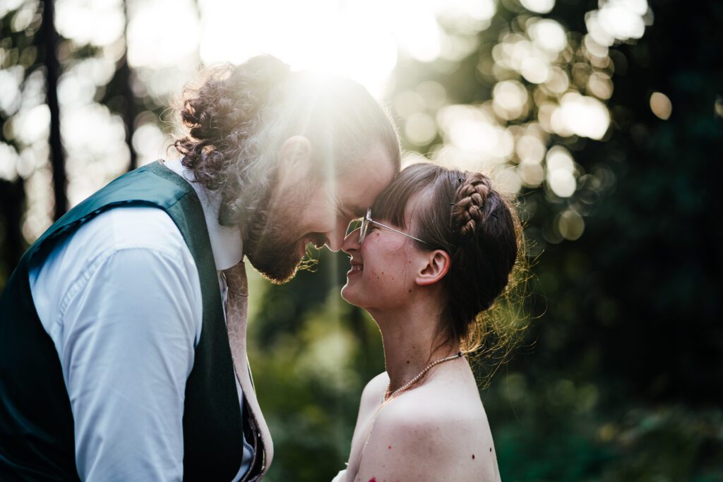 Evening Sunlight close up bride and groom portrait in the woodland at Sherwood Glade.