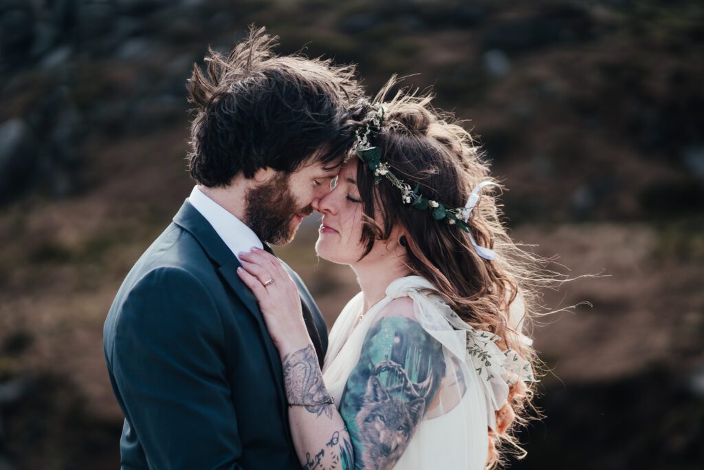 Close up of couple windswept hair with sun catching it.